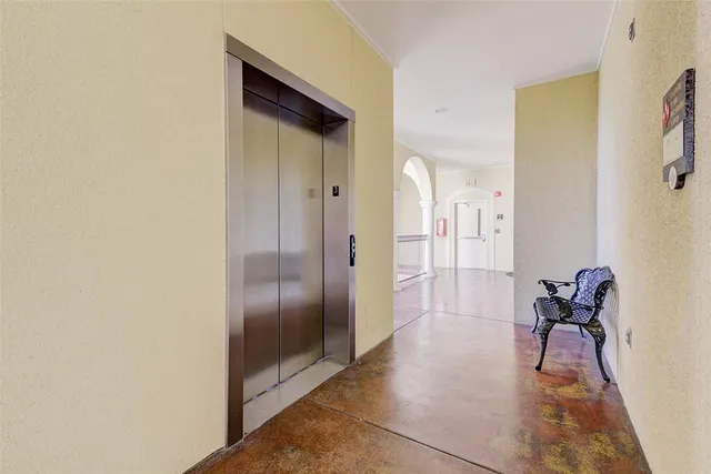a view of a hallway with wooden floor and glass door