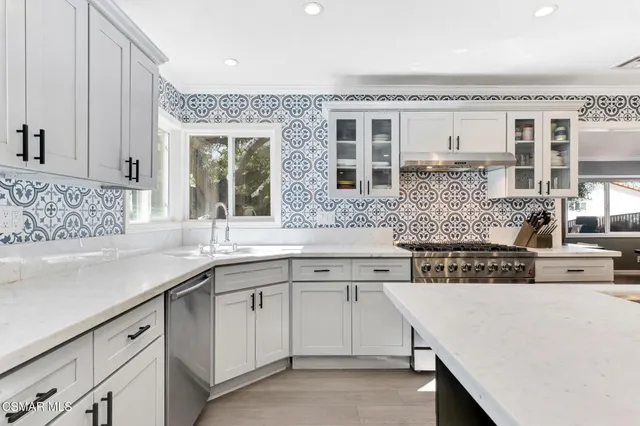 a living room with furniture and kitchen view