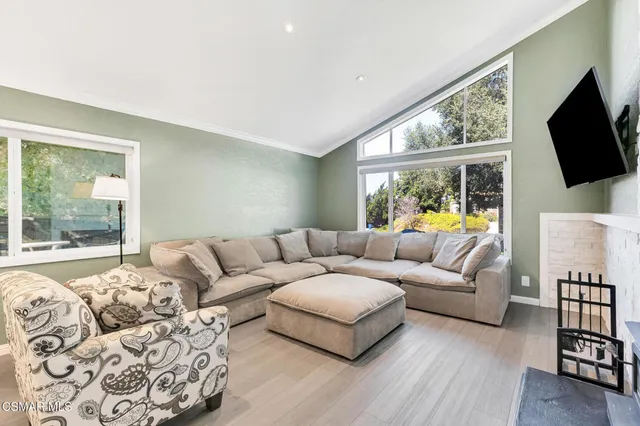 a bedroom with a large bed and a flat screen tv