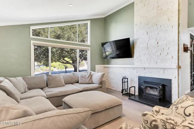 a spacious bathroom with a granite countertop double vanity sink a mirror and a toilet