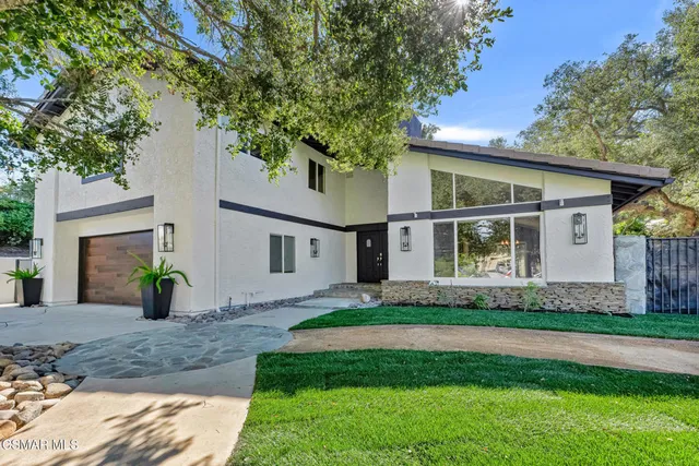 a front view of house with yard and outdoor seating