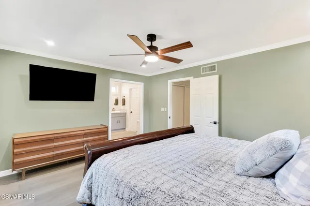 a living room with a fireplace furniture and a ceiling fan