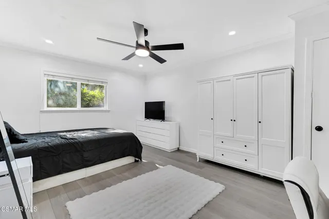 a bedroom with furniture and a flat screen tv