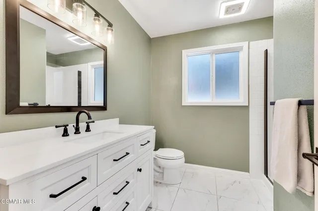 a front view of house with yard outdoor seating and covered with green space