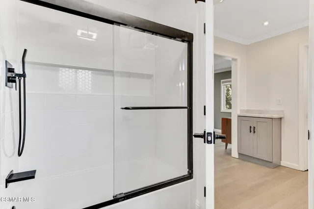 a view of backyard with table and chairs and wooden fence
