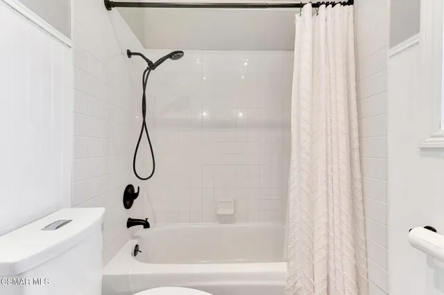 a view of a patio with table and chairs and potted plants with wooden floor and fence