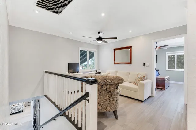 a backyard of a house with table and chairs under an umbrella