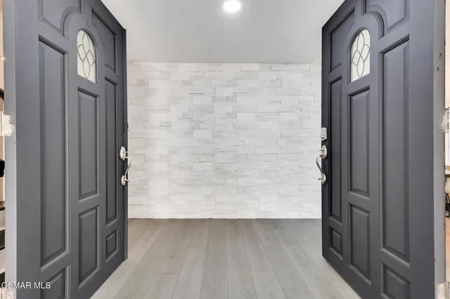 a view of staircase with lots of frames on wall and stairs