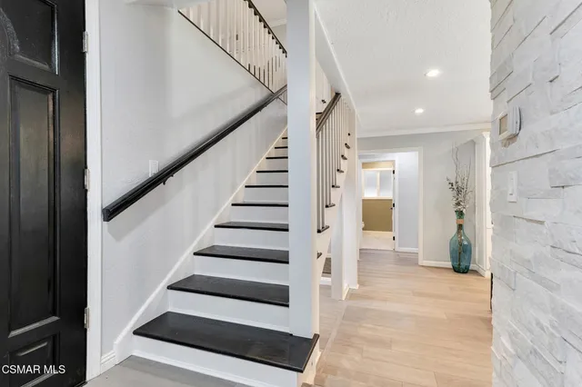 a kitchen with a dining table chairs stainless steel appliances and cabinets