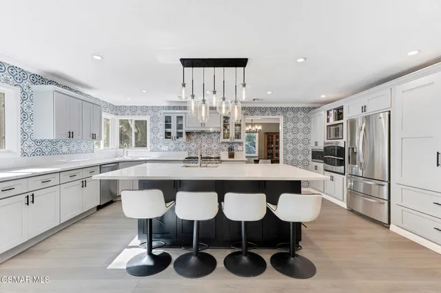 a kitchen with granite countertop a sink stove and cabinets