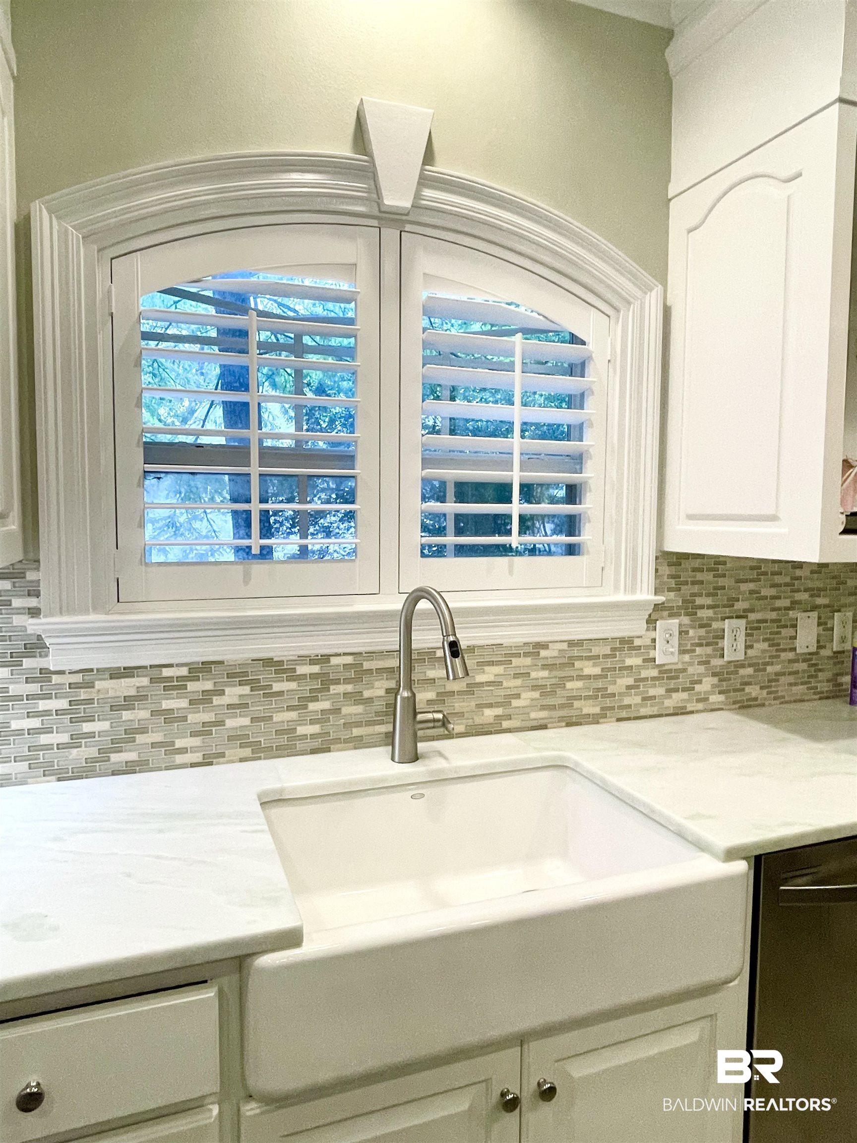 202 Potters Mills Road Daphne, AL 36526 - Photo 11 of 29 Kitchen with white cabinetry, light stone countertops, dishwashing machine, and backsplash