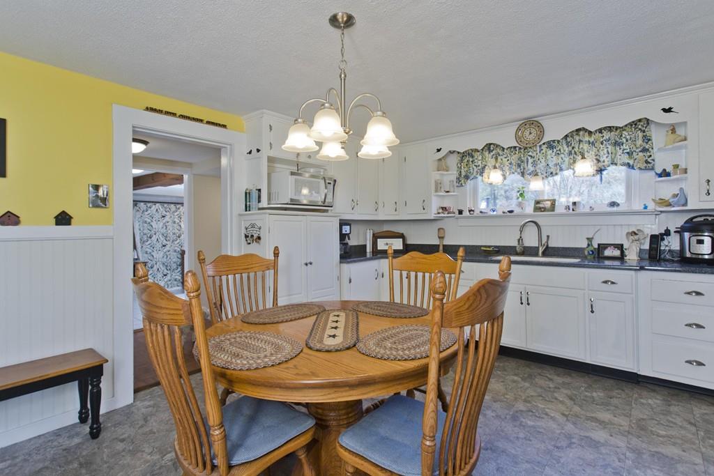 401 Palmer Road Ware, MA 01082 - Photo 15 of 34 a view of a dining room with furniture and chandelier