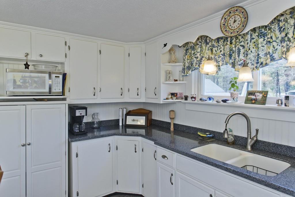 401 Palmer Road Ware, MA 01082 - Photo 17 of 34 a kitchen with stainless steel appliances a sink a stove and white cabinets