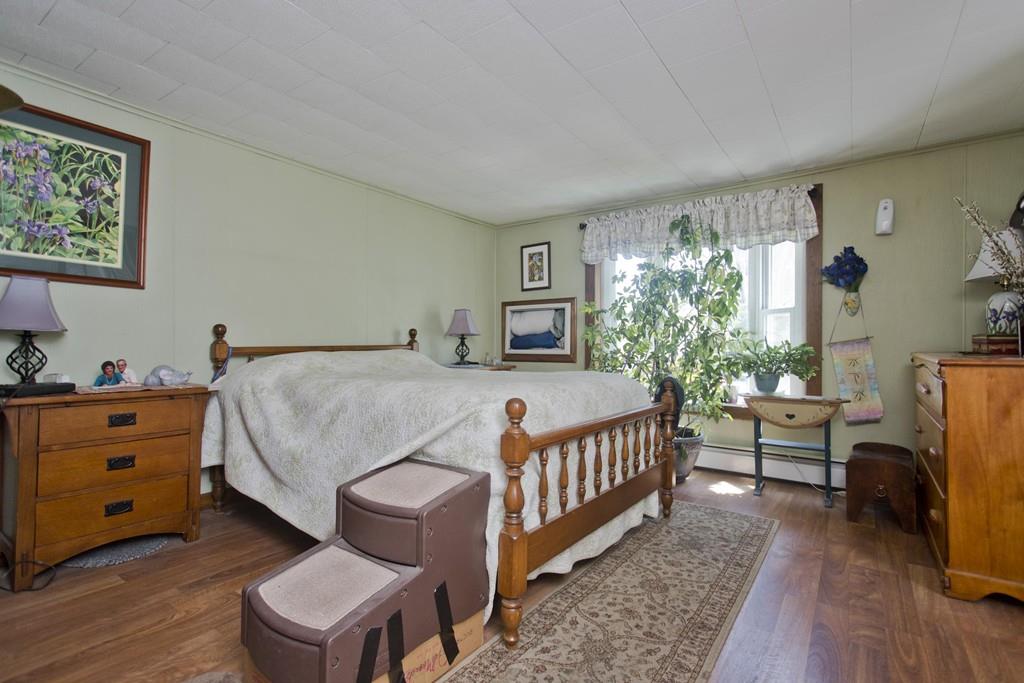 401 Palmer Road Ware, MA 01082 - Photo 24 of 34 a bedroom with a bed and a flat screen tv
