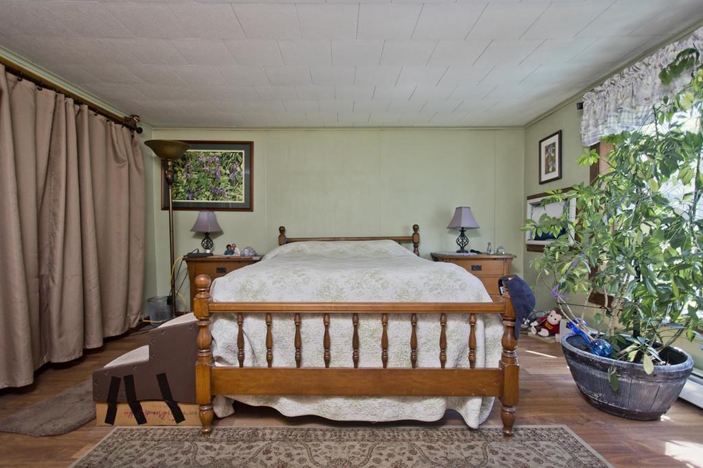 401 Palmer Road Ware, MA 01082 - Photo 27 of 34 a bed sitting in a room next to a window