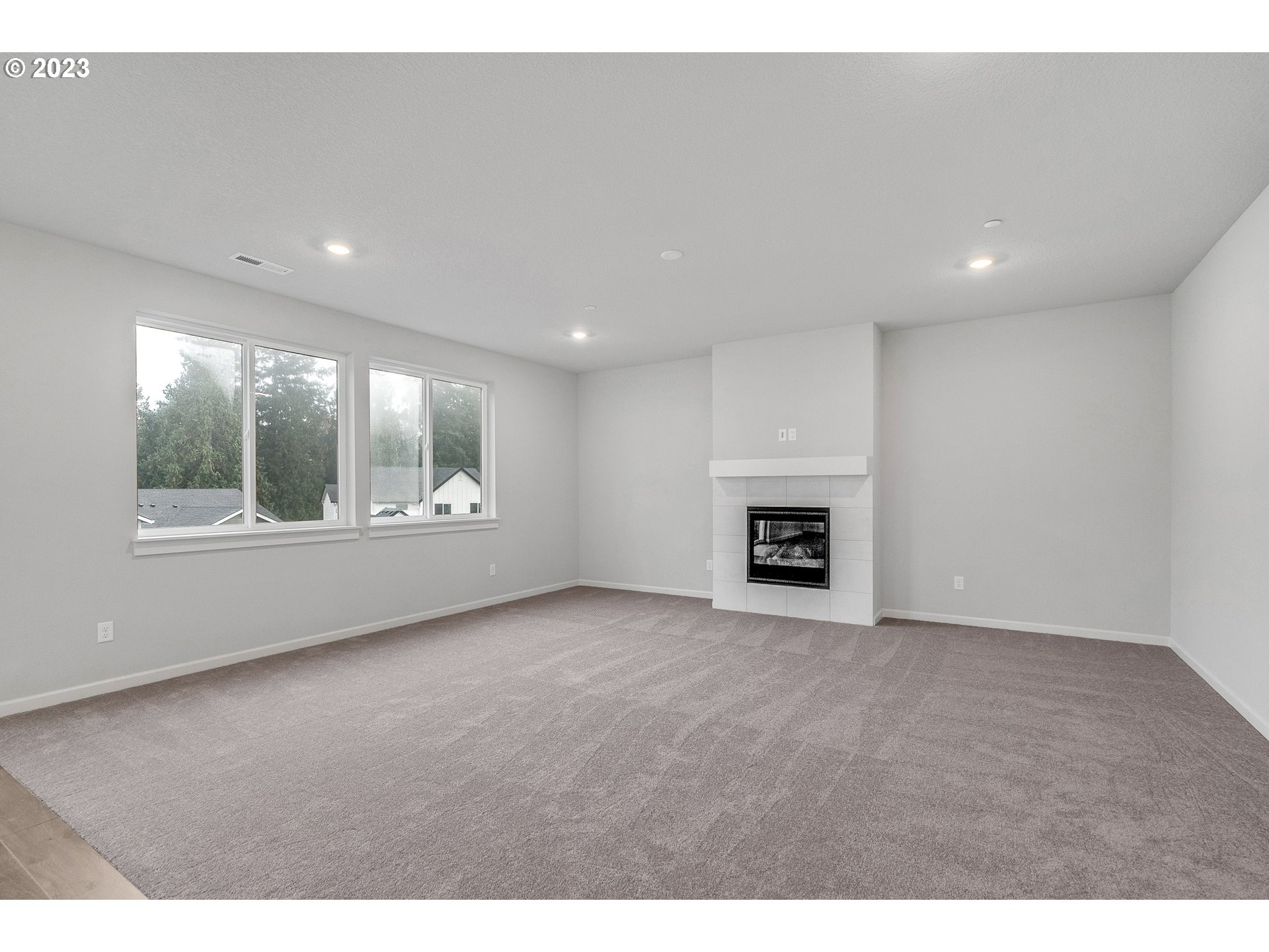 2902 South 7th Circle Ridgefield, WA 98642 - Photo 17 of 28 a view of an empty room with a window and fireplace