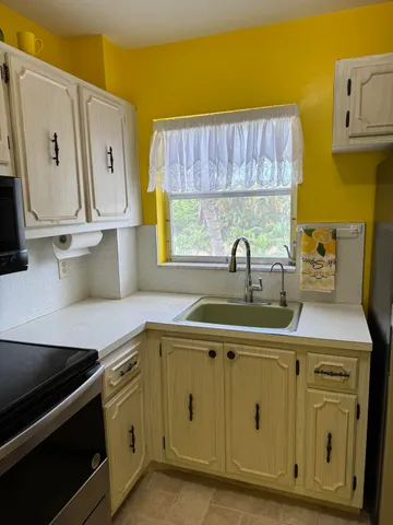 a kitchen with stainless steel appliances a sink dishwasher and cabinets