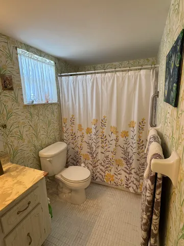 a view of bathroom with bathtub and mirror