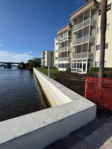 a view of swimming pool with outdoor seating and lake view