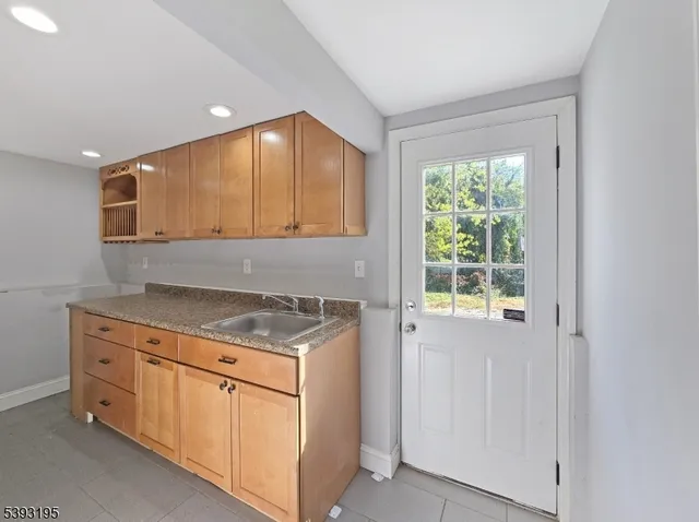 a kitchen with white cabinets and a stove top oven