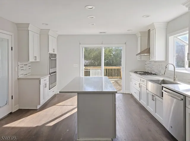 a kitchen with granite countertop a sink stove and cabinets