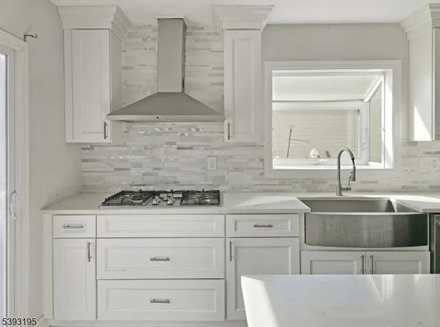 a kitchen with cabinets appliances and a counter space