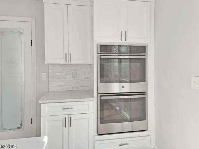 a kitchen with granite countertop cabinets stainless steel appliances and a counter top