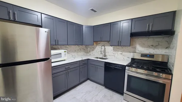 a kitchen with a sink a stove and refrigerator