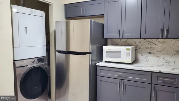 a view of a storage and utility room with washer and dryer