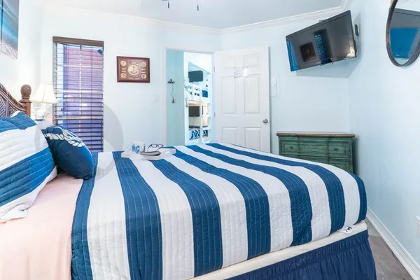 a bedroom with a bed and a flat screen tv