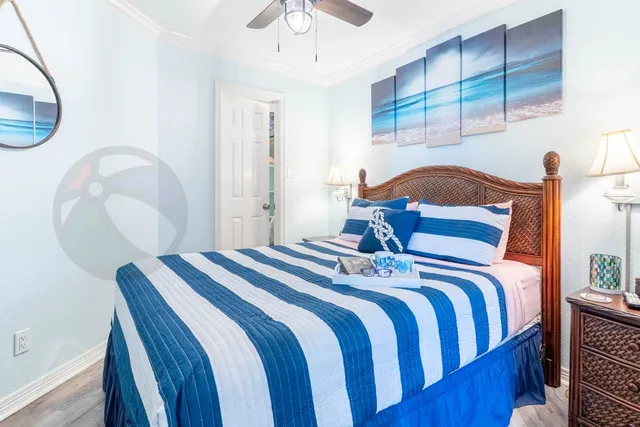 a bedroom with bed and a chandelier