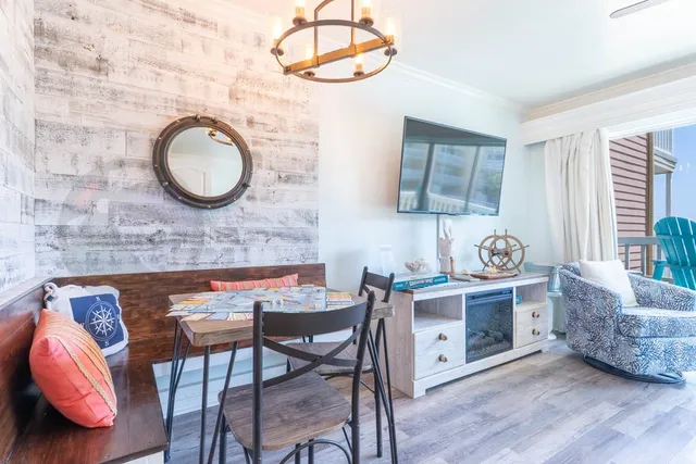 a view of a dining room with furniture and wooden floor