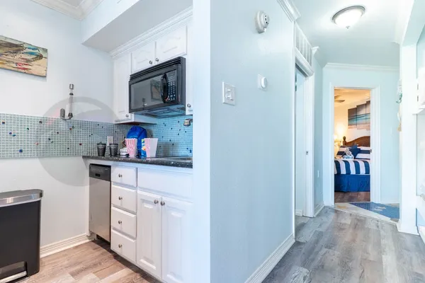 a kitchen with stainless steel appliances granite countertop a refrigerator and microwave