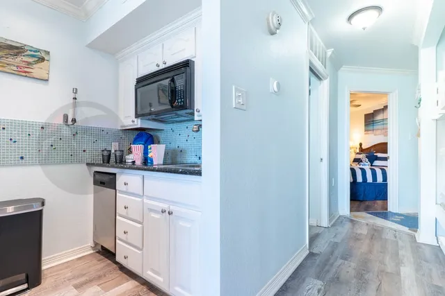 a kitchen with stainless steel appliances granite countertop a refrigerator and microwave