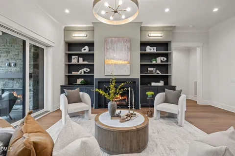 a view of kitchen with kitchen island stainless steel appliances sink stove refrigerator and couches with wooden floor