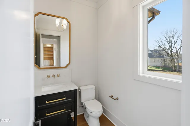 a bathroom with a toilet sink and mirror