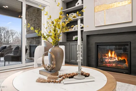 a kitchen with counter top space sink stove and living room view