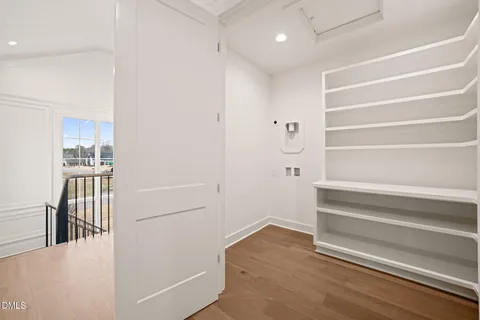 a view of a work space with wooden floor and furniture
