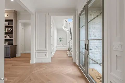 a dining room with furniture a chandelier and wooden floor