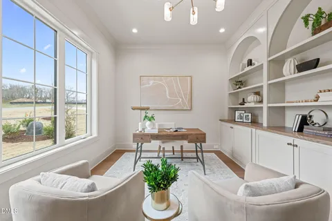 a living room with fireplace furniture dining room and wooden floor