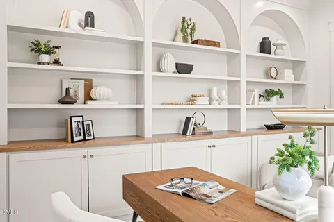 a living room with furniture and kitchen view