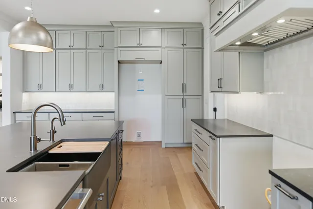 a kitchen that has a sink and a stove in it