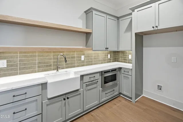 a kitchen with appliances cabinets and a sink
