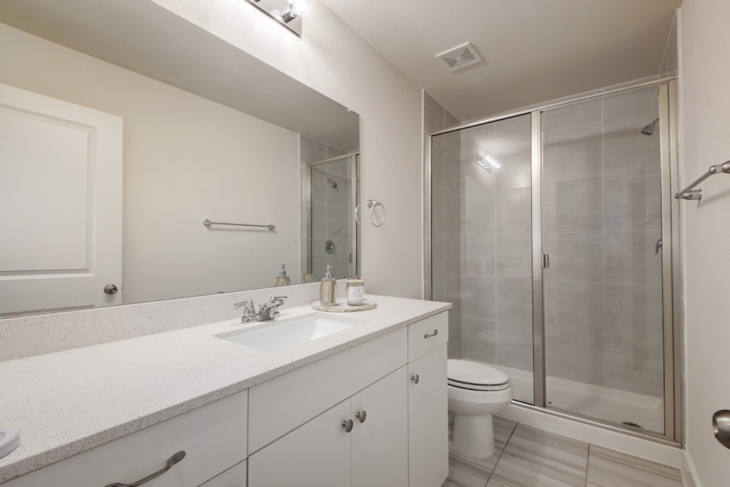 413 White Steppe Way Georgetown, TX 78626 - Photo 14 of 25 a bathroom with a sink a toilet and shower
