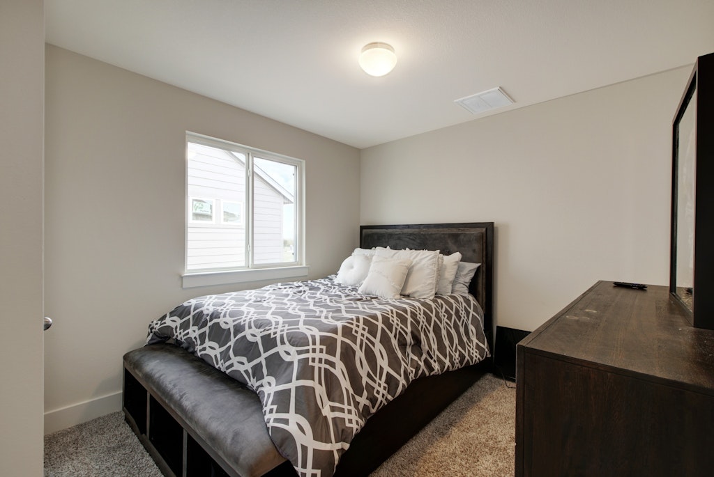 413 White Steppe Way Georgetown, TX 78626 - Photo 15 of 25 a bedroom with a bed and a window