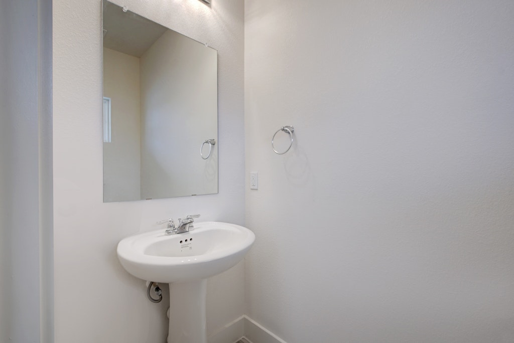 413 White Steppe Way Georgetown, TX 78626 - Photo 18 of 25 a bathroom with a sink and a mirror