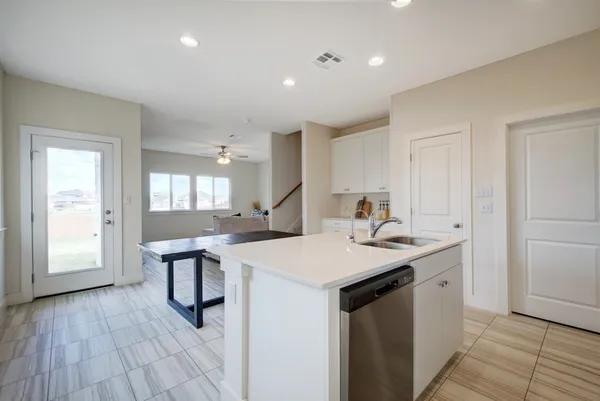 a kitchen with a sink cabinets and wooden floor