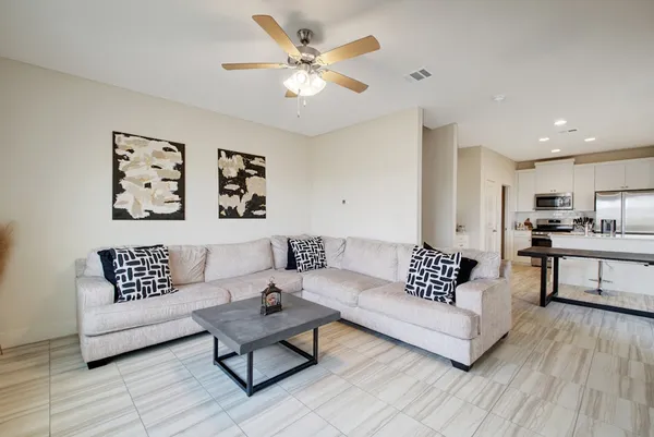 a living room with furniture and white walls