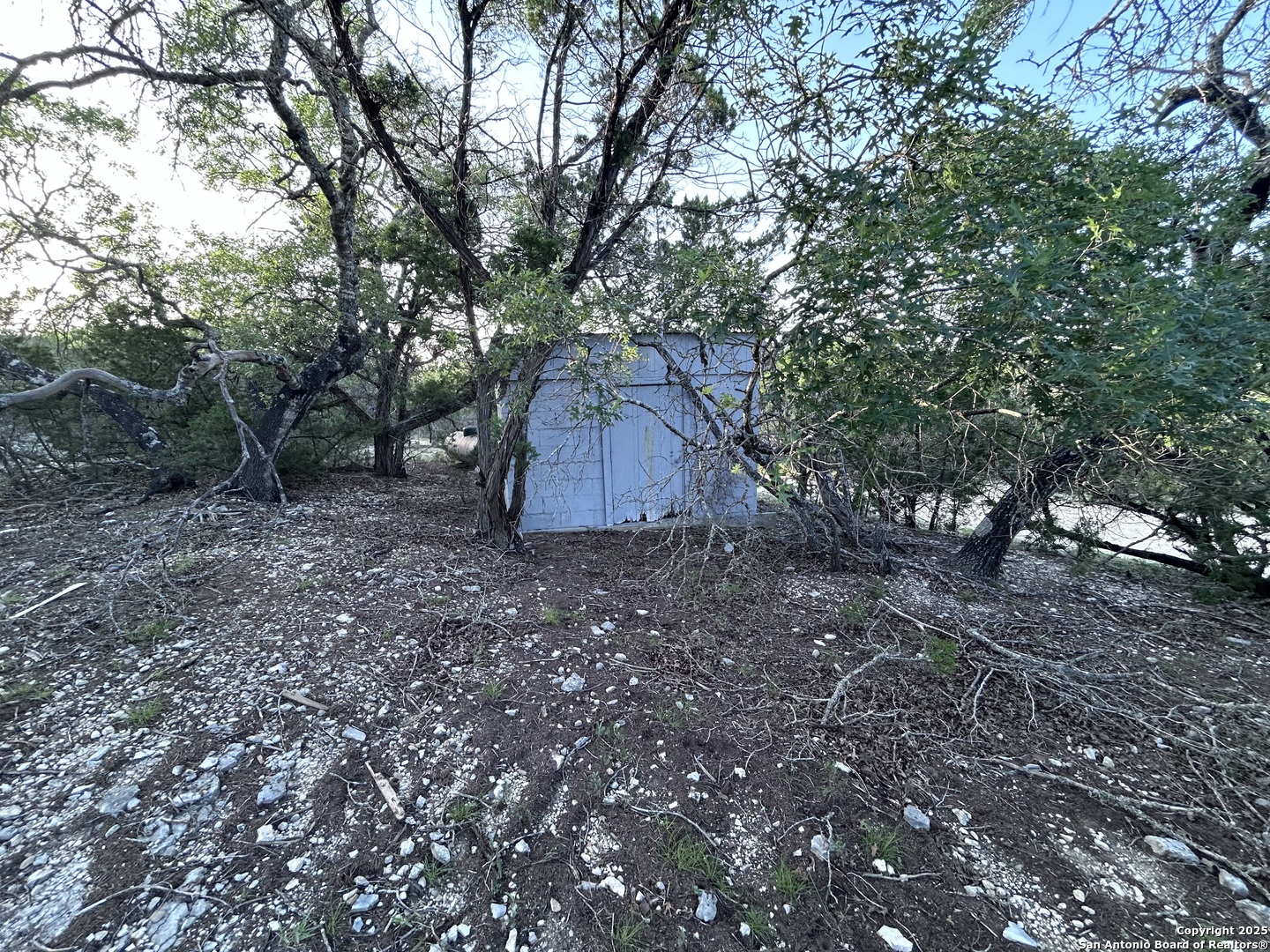 320 Frontier Lane Bandera, TX 78003 - Photo 11 of 11 a backyard of a house with lots of green space