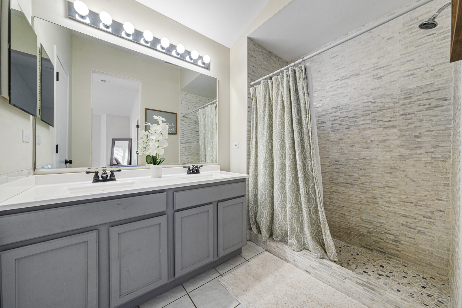 1020 Key Largo Drive Romeoville, IL 60446 - Photo 14 of 22 a bathroom with a double vanity sink a mirror and a shower